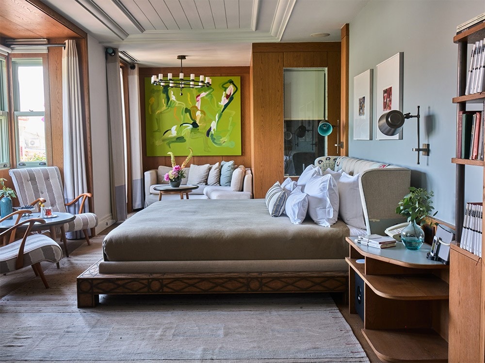 An elegant guest room with contemporary artwork and bookshelves at Alavya in Alaçatı
