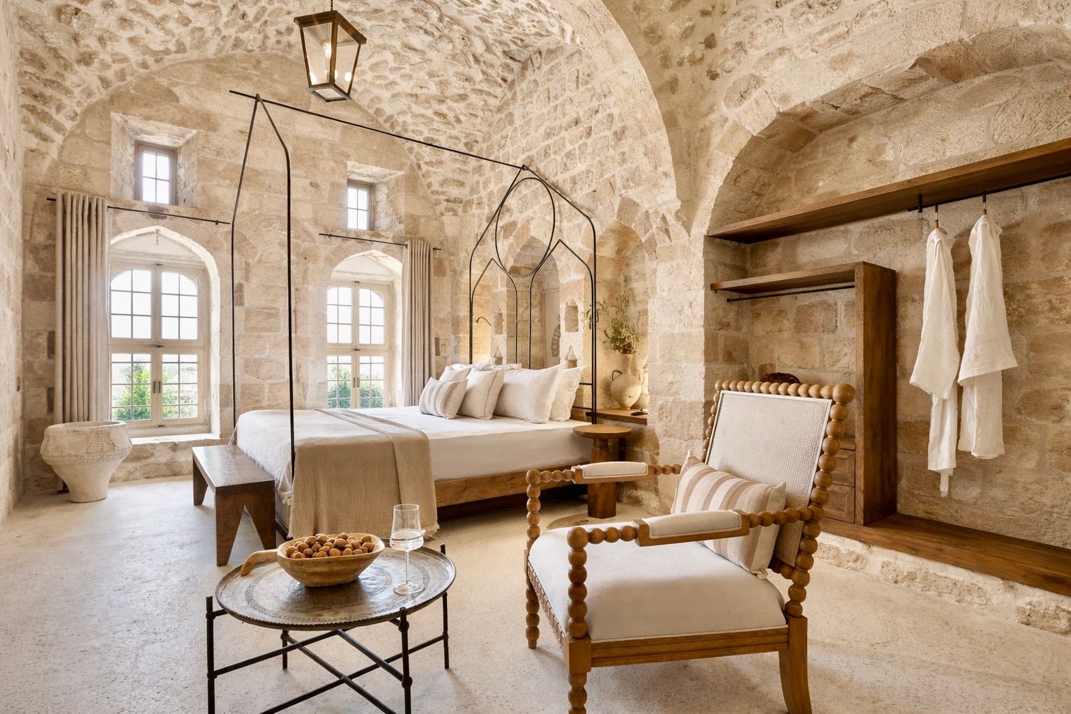 A vaulted stone-ceilinged room with a four-poster bed at Arura Mardin