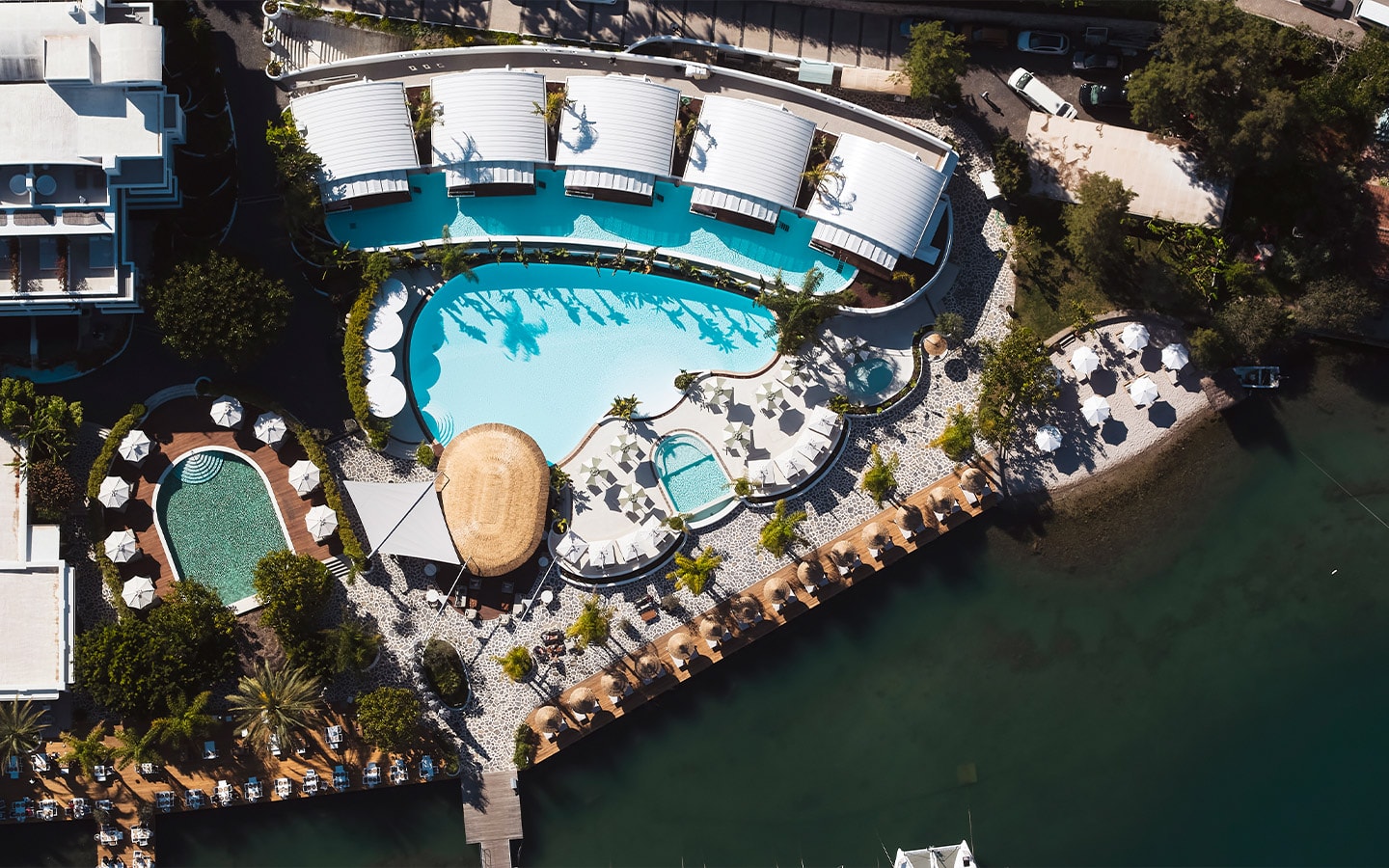 An aerial view of the waterfront pools and sun terraces of Yacht Classic Hotel in Fethiye