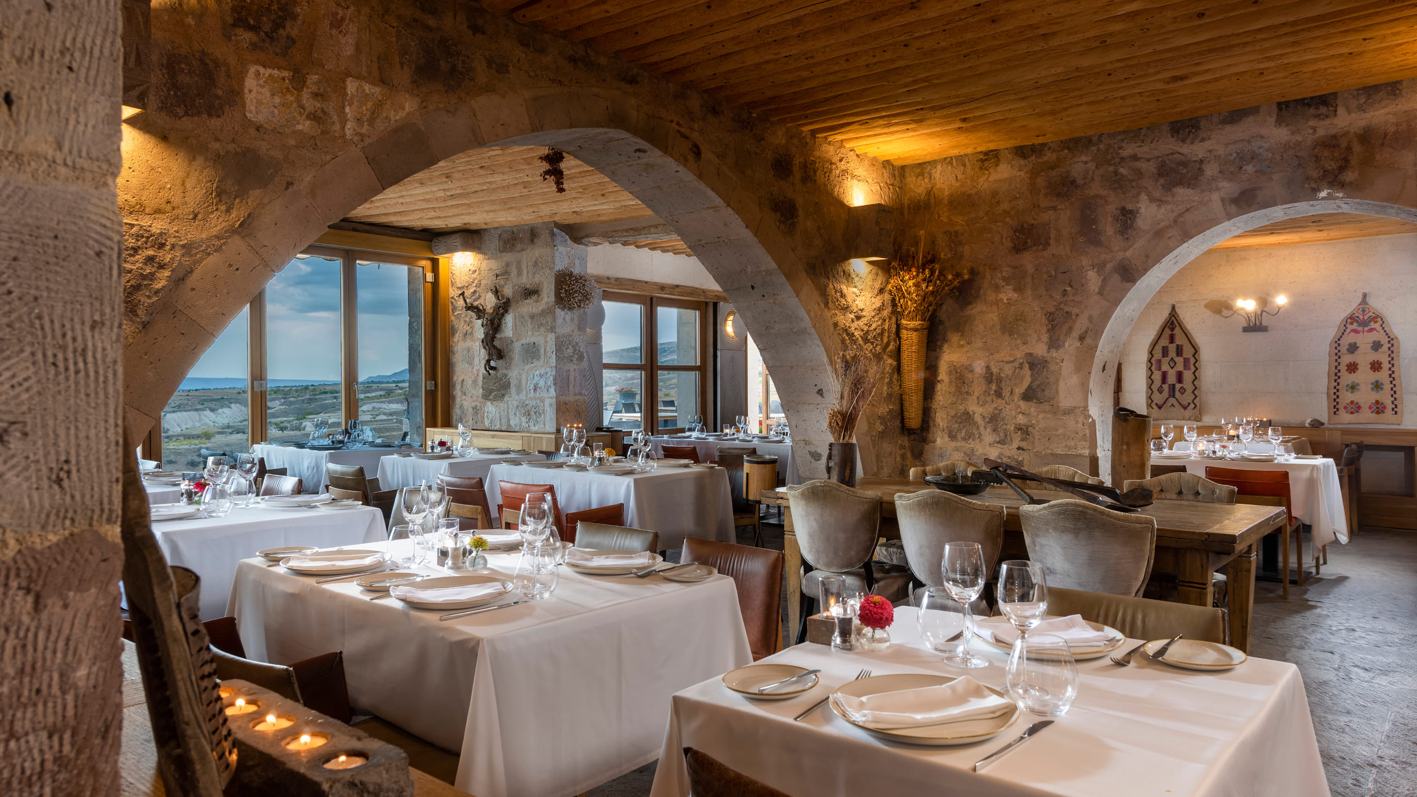 Seki Restaurant's stone-arched dining room with white tablecloths and valley windows