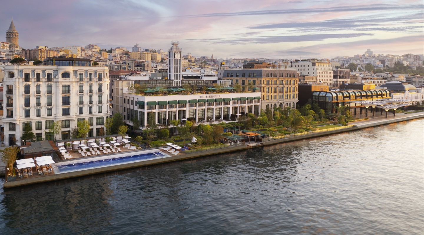 Aerial view of The Peninsula Istanbul and its waterfront pool on the Bosphorus at dusk